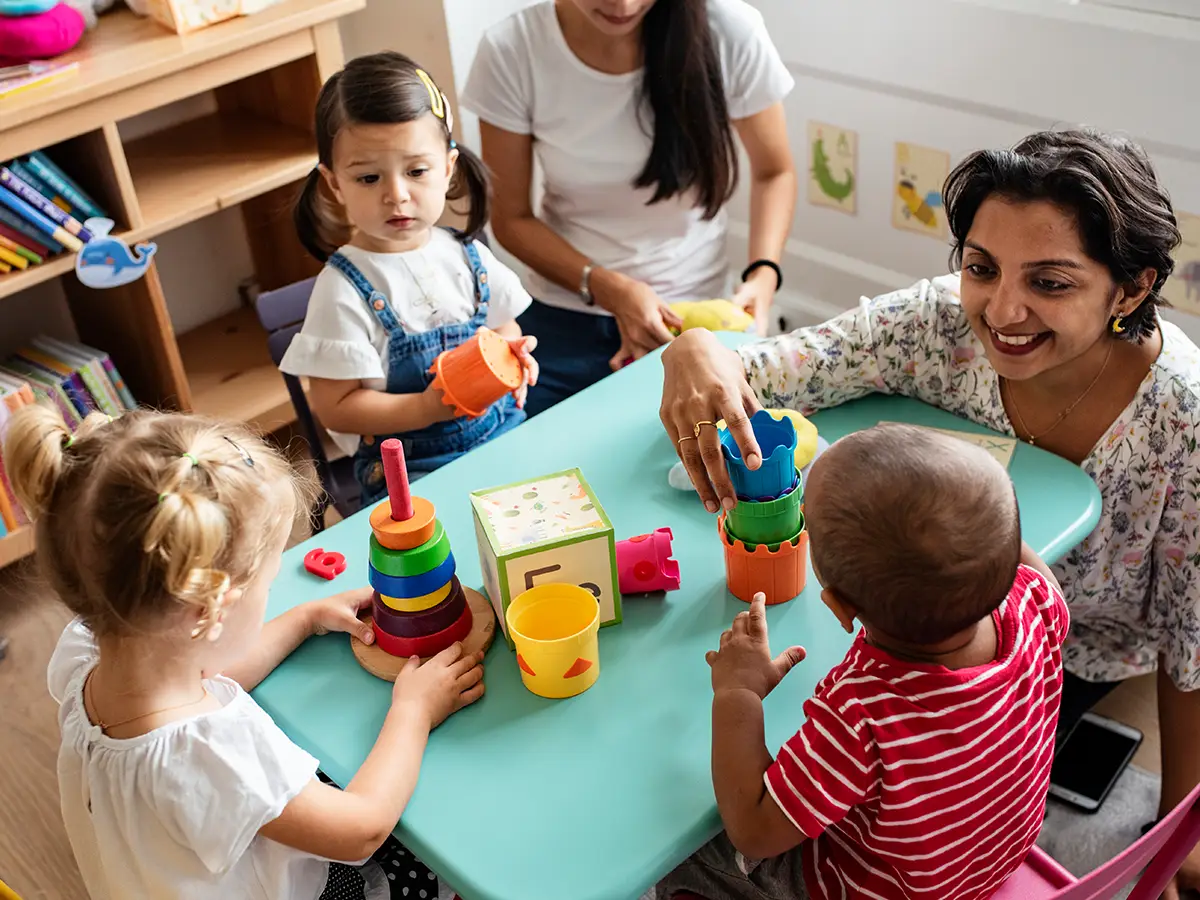 Preschool teacher interacts with children